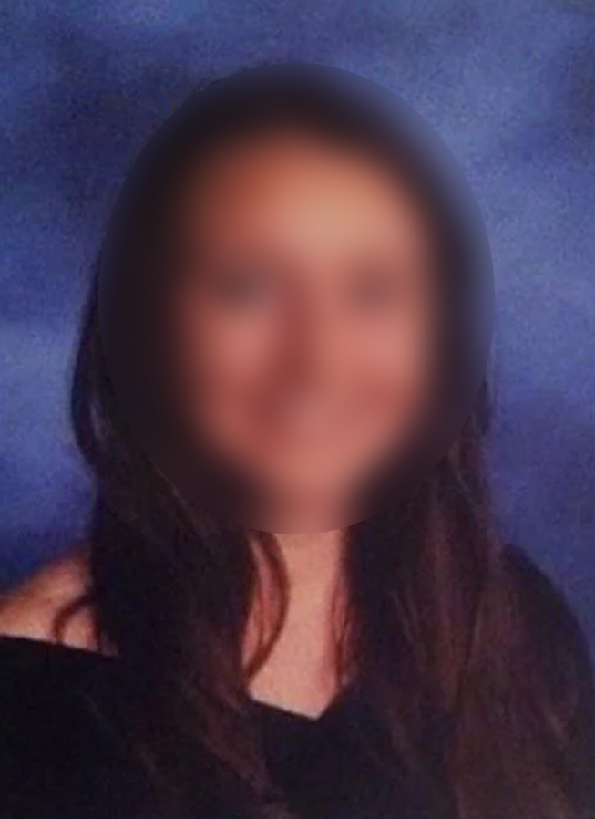 A blurry picture of a woman with long hair.