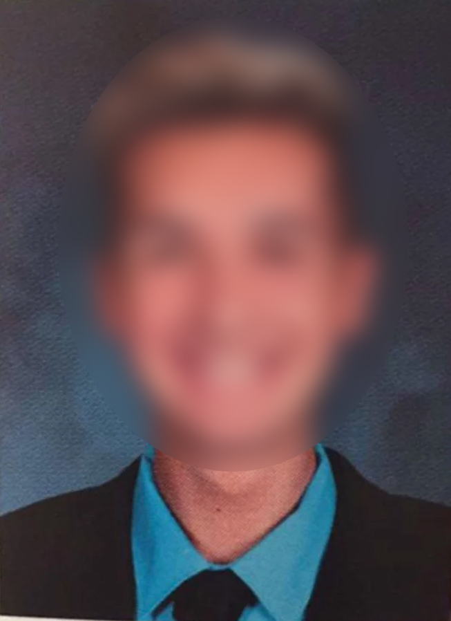 A blurry picture of a man in a suit.
